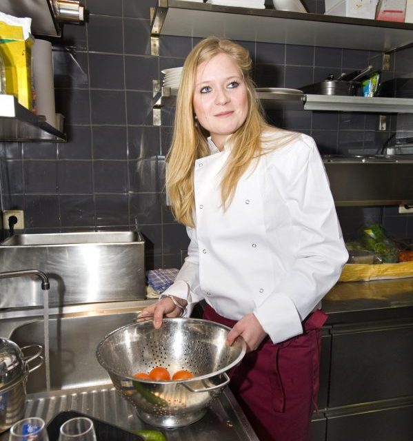 A chef and his sous-chef working in a kitchen